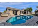 Kidney-shaped pool with a covered patio and spa at 6419 E Paradise Ln, Scottsdale, AZ 85254