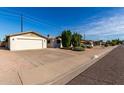 Front view of a single-story home with a spacious driveway at 6816 E Oak St, Scottsdale, AZ 85257