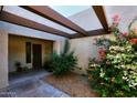 Inviting courtyard entry with wood pergola and colorful plants at 11059 E Yucca St, Scottsdale, AZ 85259