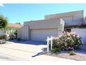 Tan two-story home with a two-car garage and desert landscaping at 11059 E Yucca St, Scottsdale, AZ 85259