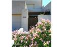 Two-story home with gated entry and blooming pink flowers at 11059 E Yucca St, Scottsdale, AZ 85259
