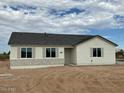 One-story house with a light-colored exterior, dark roof, and landscaping at 13634 S 192Nd Ave, Buckeye, AZ 85326
