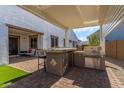 Modern outdoor kitchen with grill and bar seating at 13930 W Tierra Grande --, Surprise, AZ 85387
