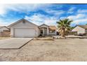 House with a large palm tree in front and a two-car garage at 142 N 86Th Pl, Mesa, AZ 85207