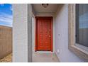 Red front door entrance to a single-story home at 1452 W Shannon Way, Coolidge, AZ 85128