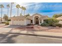 Single-story home with tile roof, two-car garage, and desert landscaping at 14543 W Bison Path, Surprise, AZ 85374