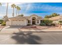 Single-story home with tile roof, two-car garage, and desert landscaping at 14543 W Bison Path, Surprise, AZ 85374