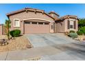 Single-story home with two-car garage and neatly landscaped front yard at 16468 W Mariposa Grande --, Surprise, AZ 85387