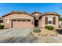 Single-story home with two-car garage, landscaping, and desert-inspired exterior at 16468 W Mariposa Grande --, Surprise, AZ 85387