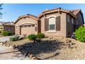 Single-story home with two-car garage and well-maintained desert landscaping at 16468 W Mariposa Grande --, Surprise, AZ 85387