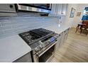 Modern kitchen with stainless steel appliances and stylish backsplash at 17221 W Middlebury St, Surprise, AZ 85388