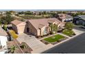 Single-story home with a three-car garage and manicured lawn at 21774 E Camacho Rd, Queen Creek, AZ 85142