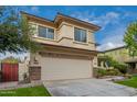 Two-story house with beige exterior, stone accents, and a two-car garage at 4234 E Washington Ct, Gilbert, AZ 85234