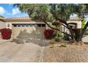 Tan stucco house with two-car garage and nicely landscaped front yard at 7979 E Princess Dr # 13, Scottsdale, AZ 85255