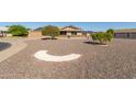 Landscaped front yard with gravel, small trees, and decorative rock features at 10425 N Balboa Dr, Sun City, AZ 85351