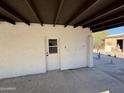 Whitewashed exterior wall with covered patio and door at 114 E 12Th St, Eloy, AZ 85131