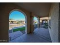 Covered porch with arched entryway and view of the neighborhood at 16071 W Sand Hills Rd, Surprise, AZ 85387