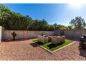 Landscaped backyard with fire pit and seating area at 18803 N 33Rd Dr, Phoenix, AZ 85027