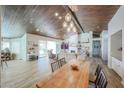 Bright dining area with a farmhouse table and access to the living room at 19418 N 86Th Dr, Peoria, AZ 85382