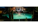 Inviting pool at night with surrounding landscape lighting at 24200 N Alma School Rd # 29, Scottsdale, AZ 85255