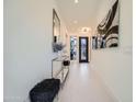 Bright entryway with contemporary console table and art at 37200 N Cave Creek Rd # 1119, Scottsdale, AZ 85262