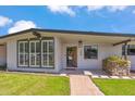 Front view of a mid-century modern home with a walkway and updated facade at 7255 N 12Th St, Phoenix, AZ 85020