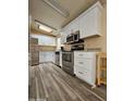 Modern kitchen with stainless steel appliances and white cabinets at 8600 E Broadway Rd # 55, Mesa, AZ 85208