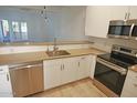Modern kitchen with stainless steel appliances and light brown countertops at 1217 N Miller Rd # 8, Scottsdale, AZ 85257