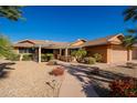 Single-story home with a covered patio and landscaped yard at 12434 W Eveningside Dr, Sun City West, AZ 85375