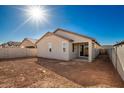 Back exterior of a single-story home with a covered patio and a fenced backyard at 13248 W Hackamore Dr, Peoria, AZ 85383