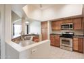 Modern kitchen with stainless steel appliances and wood cabinets at 1331 W Baseline Rd # 329, Mesa, AZ 85202