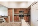 Modern kitchen with stainless steel appliances and wood cabinets at 1331 W Baseline Rd # 329, Mesa, AZ 85202