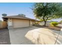 House exterior showcasing a garage and driveway at 2601 E Garnet Ave, Mesa, AZ 85204