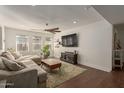 Spacious living room featuring a sectional sofa and hardwood floors at 2601 E Garnet Ave, Mesa, AZ 85204