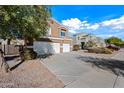 Two-story house with a three-car garage and front yard at 35920 W Cartegna Ln, Maricopa, AZ 85138