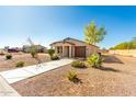 A single-story home with a driveway and walkway leading to the front door, surrounded by desert landscaping at 15580 S Bentley Dr, Arizona City, AZ 85123