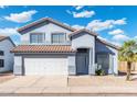 Two-story house with gray exterior, white garage door, and a terracotta roof at 23854 N 36Th Dr, Glendale, AZ 85310