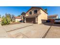 Two-story house with a large driveway and desert landscaping at 3619 N 104Th Dr, Avondale, AZ 85392