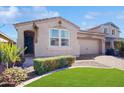 Tan colored house with a neatly landscaped yard at 30855 N 138Th Ave, Peoria, AZ 85383