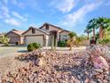 Single story home with a two-car garage and nicely landscaped yard at 533 S 230Th Ave, Buckeye, AZ 85326