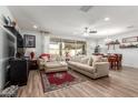 Comfortable living room with beige sofa, ottoman, and a large TV at 1358 N St Paul --, Mesa, AZ 85205