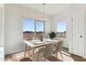 Charming dining area with a table for four and large windows at 20236 W Highland Ave, Litchfield Park, AZ 85340
