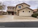 Two-story house with a landscaped yard and attached two-car garage at 22130 N Van Loo Dr, Maricopa, AZ 85138