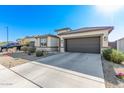 Modern stucco home with a two-car garage and nicely landscaped front yard at 23945 W Zak Rd, Buckeye, AZ 85326