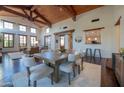 Bright dining room with wooden table and chairs, adjacent to the living area at 10575 E Rising Sun Dr, Scottsdale, AZ 85262