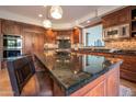 Gourmet kitchen with dark wood cabinetry, granite counters, and high-end appliances at 10575 E Rising Sun Dr, Scottsdale, AZ 85262