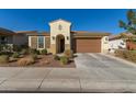 Single-story home with a two-car garage and desert landscaping at 19950 W Heatherbrae Dr, Litchfield Park, AZ 85340