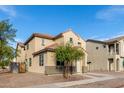 Two-story house with a beige exterior, two-car garage, and landscaping at 5438 W Odeum Ln, Phoenix, AZ 85043