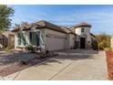 Single-story home with a two-car garage and desert landscaping at 12314 N 147Th Dr, Surprise, AZ 85379