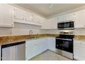 Well-equipped kitchen with granite countertops and white cabinets at 15050 N Thompson Peak Pkwy # 1012, Scottsdale, AZ 85260